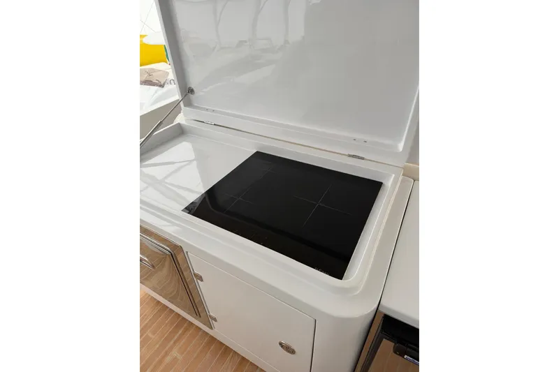  Yacht Photos Pics 2023 Zeta Elle 20 yacht kitchen with sleek induction cooktop.