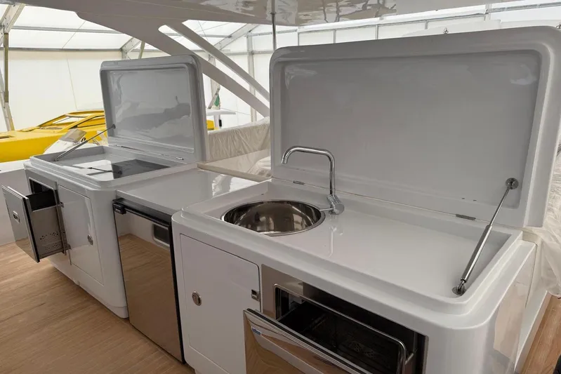  Yacht Photos Pics Modern yacht kitchen with sink, stove, and storage on Zeta Elle 20, 2023 model.