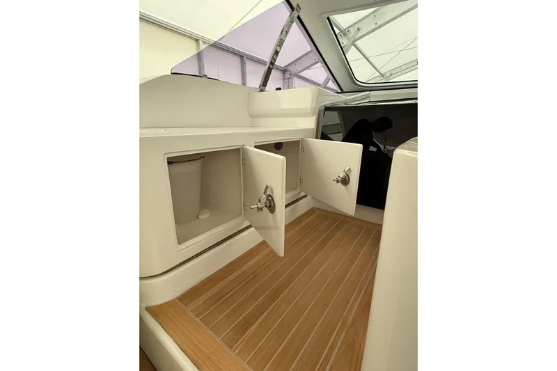  Yacht Photos Pics Interior of 2023 Zeta Elle 20 boat with open storage compartments.