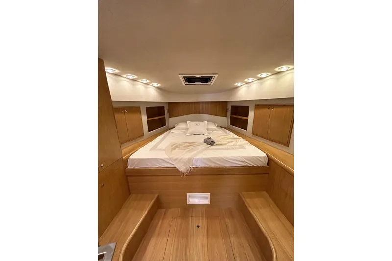  Yacht Photos Pics Luxurious cabin interior of 2023 Zeta Elle 20 yacht with cozy bed and ambient lighting.