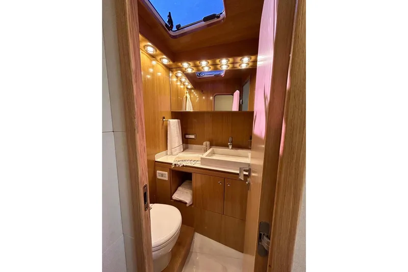  Yacht Photos Pics Luxurious 2023 Zeta Elle 20 yacht bathroom with wood finish and modern fixtures.