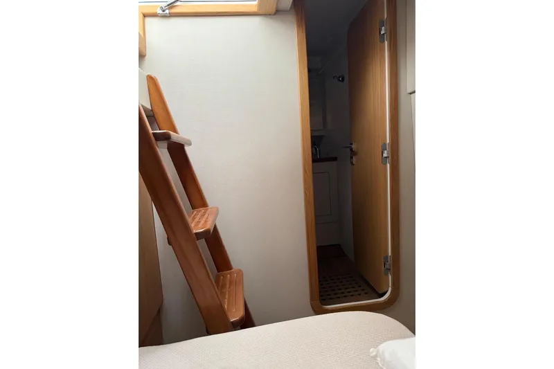  Yacht Photos Pics Interior of 2023 Zeta Elle 20 yacht with wooden ladder and open door.