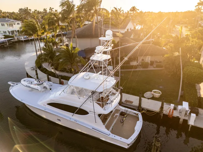 Cast Away Yacht Photos Pics 2008 Hatteras 68 Convertible yacht docked at sunset near waterfront homes.