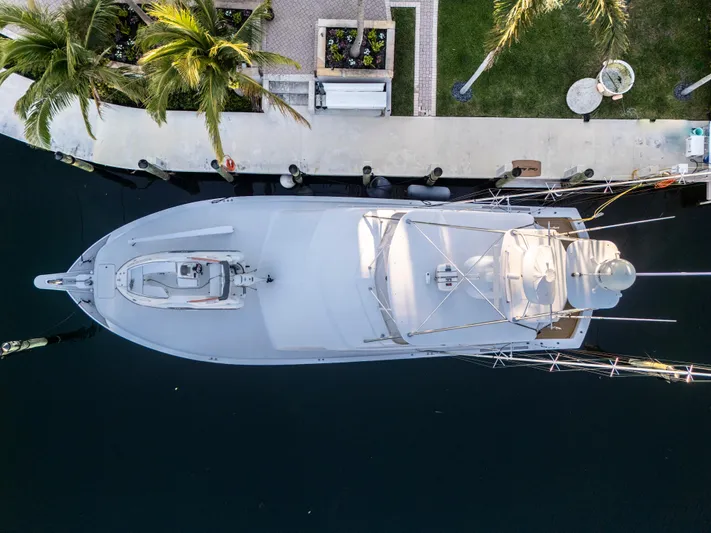 Cast Away Yacht Photos Pics Aerial view of 2008 Hatteras 68 Convertible yacht docked by palm trees.