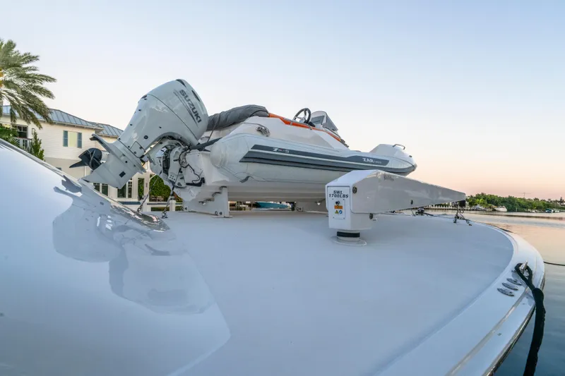 Cast Away Yacht Photos Pics 2008 Hatteras 68 Convertible yacht with a mounted inflatable boat on deck.