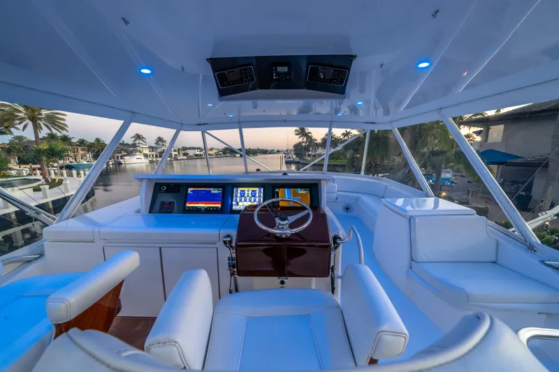 Cast Away Yacht Photos Pics 2008 Hatteras 68 Convertible yacht cockpit with modern navigation system and luxurious seating.