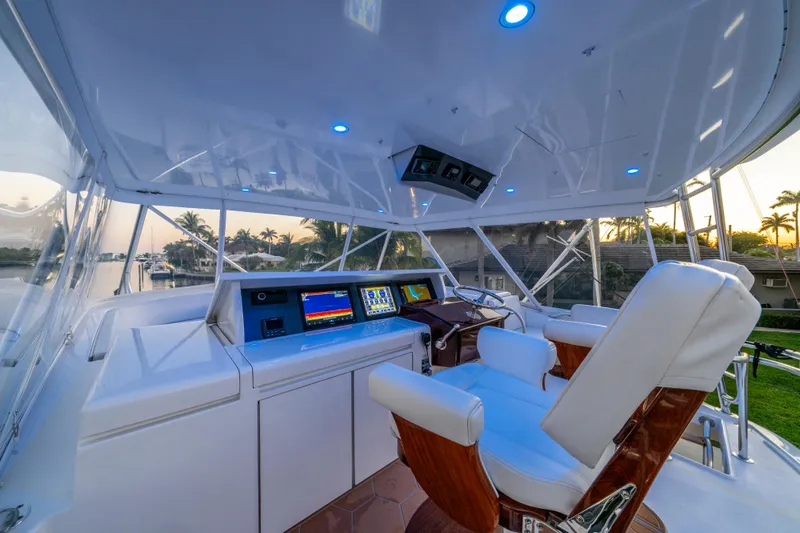 Cast Away Yacht Photos Pics Helm of 2008 Hatteras 68 Convertible yacht with modern navigation equipment and luxurious seating.