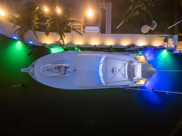 Cast Away Yacht Photos Pics Aerial view of 2008 Hatteras 68 Convertible yacht docked with colorful lights.