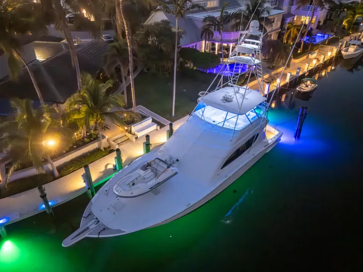 Cast Away Yacht Photos Pics 2008 Hatteras 68 Convertible yacht illuminated at night in a marina setting.