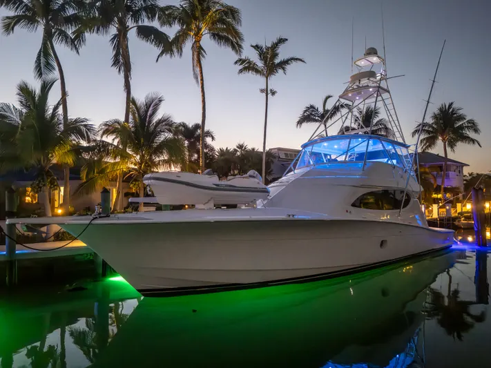 Cast Away Yacht Photos Pics 2008 Hatteras 68 Convertible yacht docked at sunset with vibrant lighting.