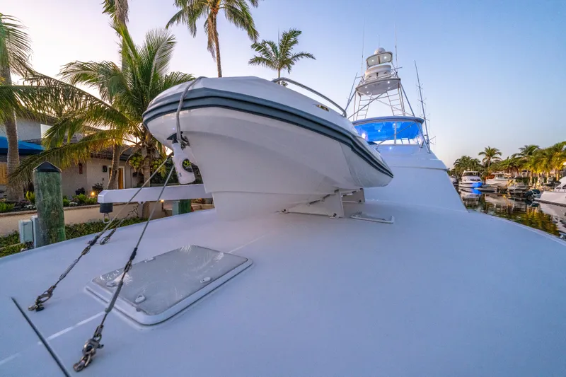 Cast Away Yacht Photos Pics 2008 Hatteras 68 Convertible yacht docked, featuring sleek design and palm trees in the background.