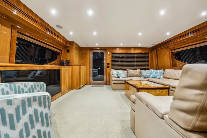 Cast Away Yacht Photos Pics Luxurious interior of 2008 Hatteras 68 Convertible yacht with plush seating and elegant wood finishes.