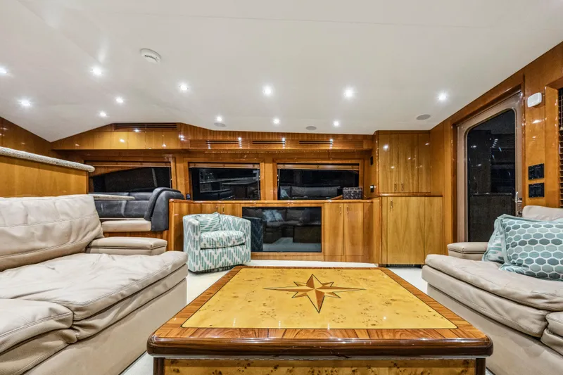 Cast Away Yacht Photos Pics Luxurious interior of 2008 Hatteras 68 Convertible yacht with elegant wood finishes.
