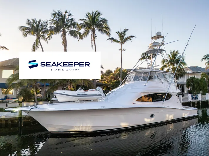 Cast Away Yacht Photos Pics 2008 Hatteras 68 Convertible yacht with Seakeeper stabilization, docked near palm trees.