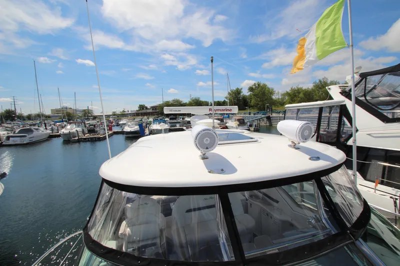  Yacht Photos Pics 2008 Sea Ray 44 Sundancer yacht docked at marina under blue sky.