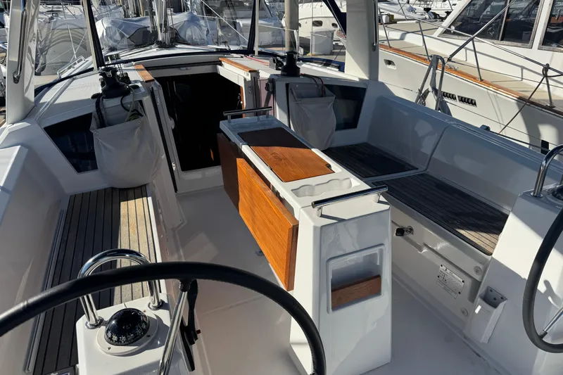 Viento Yacht Photos Pics 2018 Beneteau Oceanis 35.1 yacht cockpit with wooden accents and steering wheel.