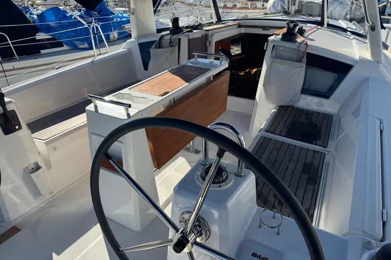 Viento Yacht Photos Pics Cockpit of 2018 Beneteau Oceanis 35.1 sailboat with steering wheel and seating area.