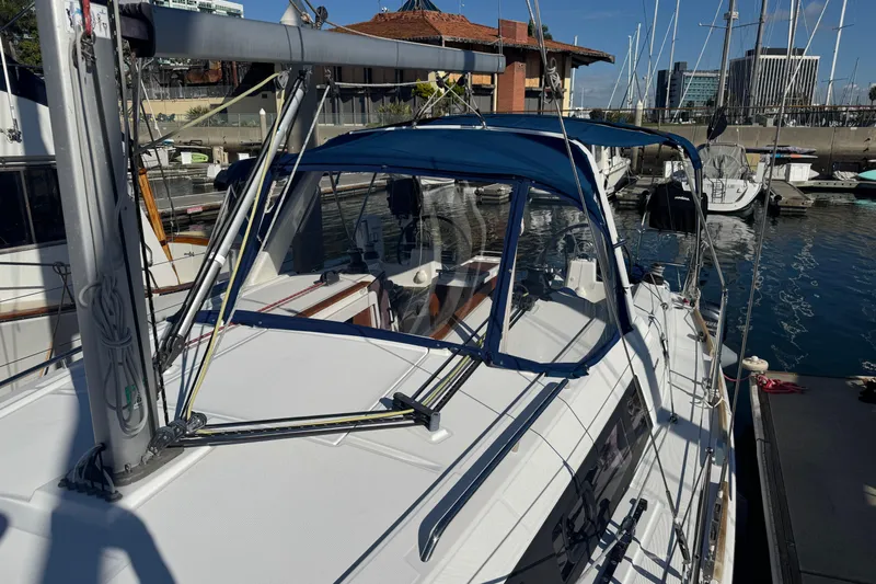 Viento Yacht Photos Pics 2018 Beneteau Oceanis 35.1 sailboat docked in a marina under clear blue skies.
