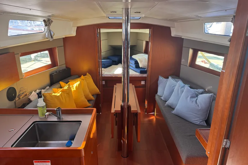 Viento Yacht Photos Pics Interior of 2018 Beneteau Oceanis 35.1 sailboat with cozy seating and modern kitchen area.
