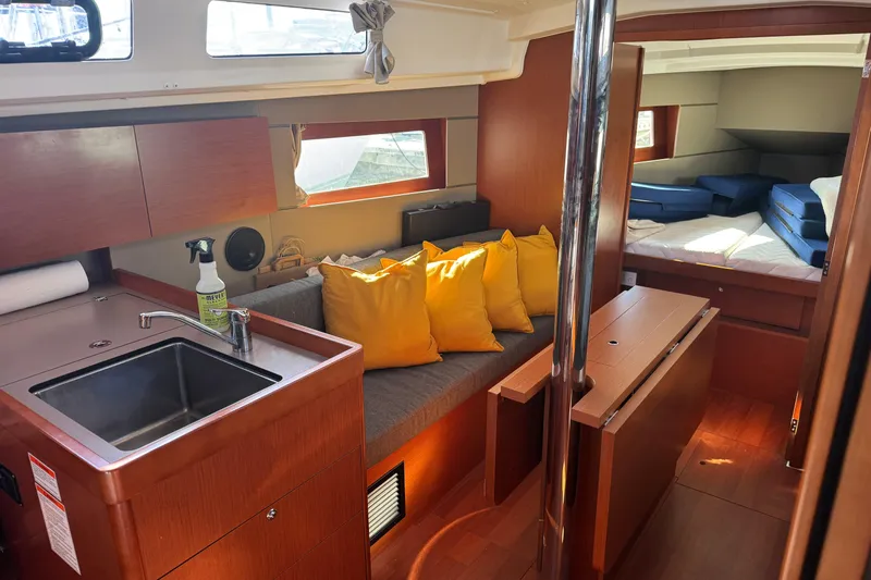 Viento Yacht Photos Pics Interior of 2018 Beneteau Oceanis 35.1 yacht with kitchen, seating, and sleeping area.