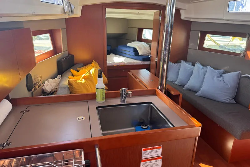 Viento Yacht Photos Pics Interior of 2018 Beneteau Oceanis 35.1 yacht with cozy seating and modern kitchen area.