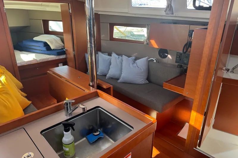 Viento Yacht Photos Pics Interior of 2018 Beneteau Oceanis 35.1 yacht with cozy seating and modern kitchen area.