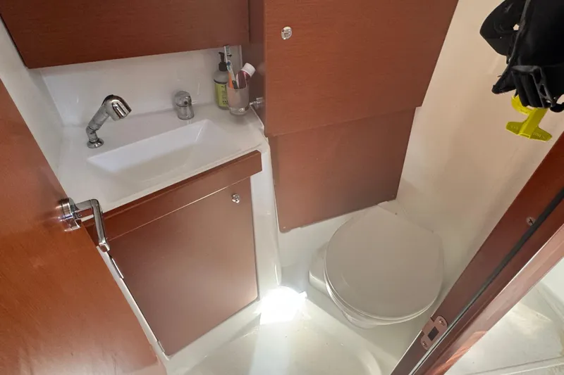 Viento Yacht Photos Pics 2018 Beneteau Oceanis 35.1 bathroom with sink, toilet, and wooden cabinetry.