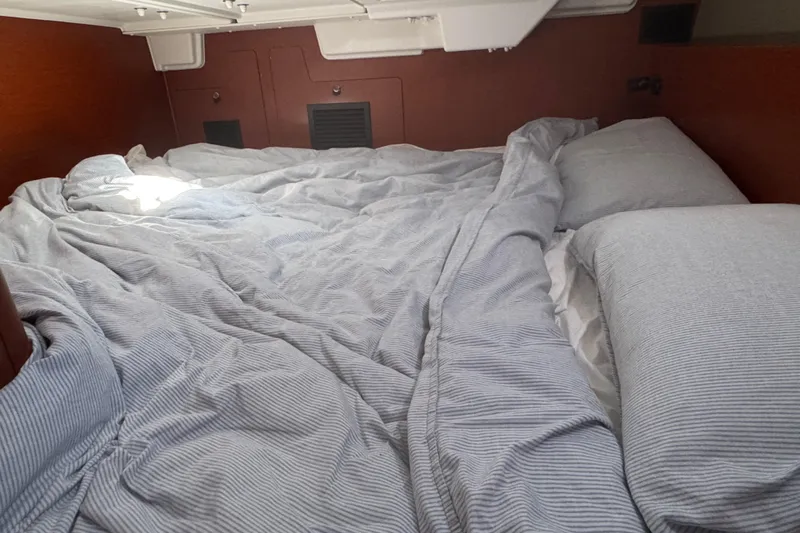 Viento Yacht Photos Pics Cozy cabin bed in 2018 Beneteau Oceanis 35.1 sailboat with striped bedding.