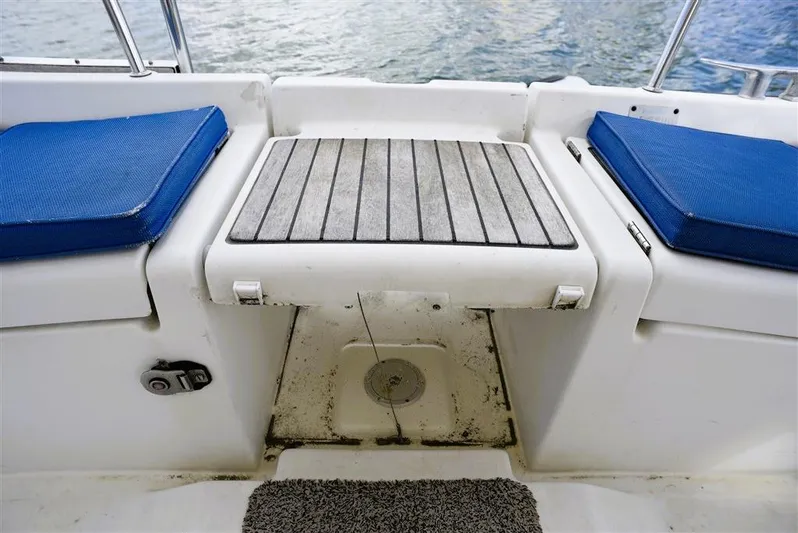  Yacht Photos Pics Beneteau Oceanis 473, 2002, cockpit with blue cushions and wooden flooring.