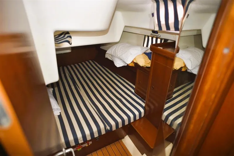  Yacht Photos Pics Interior of 2002 Beneteau Oceanis 473 yacht with striped mattresses.