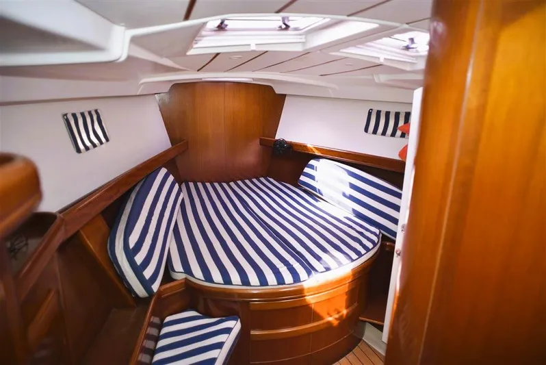  Yacht Photos Pics Interior of 2002 Beneteau Oceanis 473 yacht with striped bedding.