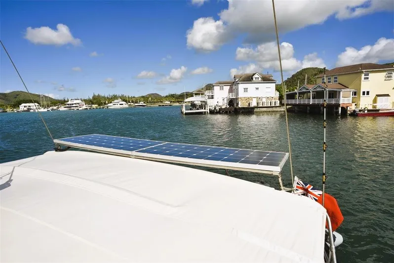  Yacht Photos Pics Beneteau Oceanis 473 yacht with solar panel, 2002, in scenic harbor.