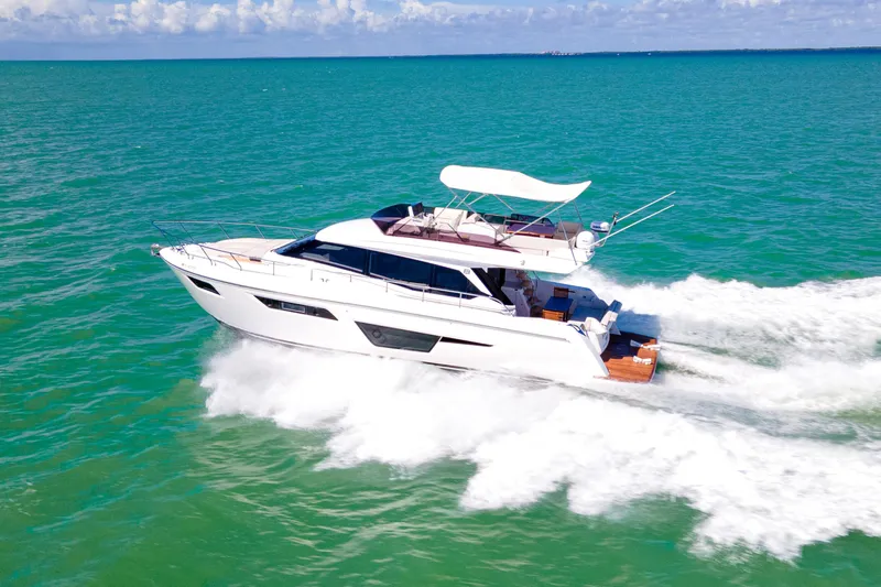 Avanti Yacht Photos Pics 2022 Ferretti Yachts 500 cruising on turquoise waters under a clear sky.