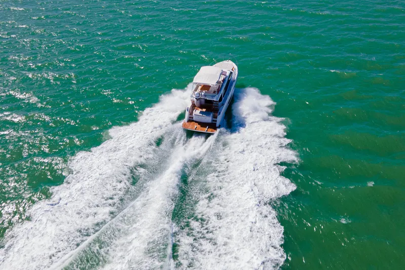 Avanti Yacht Photos Pics 2022 Ferretti Yachts 500 cruising on open sea, creating dynamic water trails.