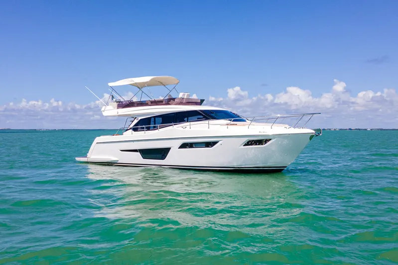 Avanti Yacht Photos Pics 2022 Ferretti Yachts 500 cruising on clear blue waters under a sunny sky.
