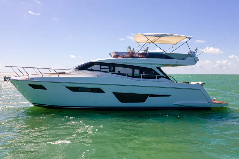 Avanti Yacht Photos Pics 2022 Ferretti Yachts 500 cruising on clear blue waters under a sunny sky.