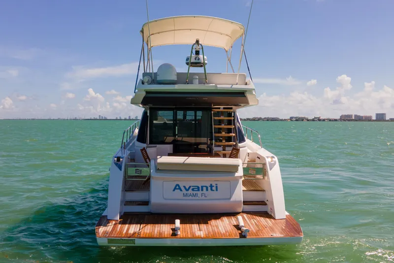 Avanti Yacht Photos Pics 2022 Ferretti Yachts 500 on water, rear view, sunny day, Miami skyline.