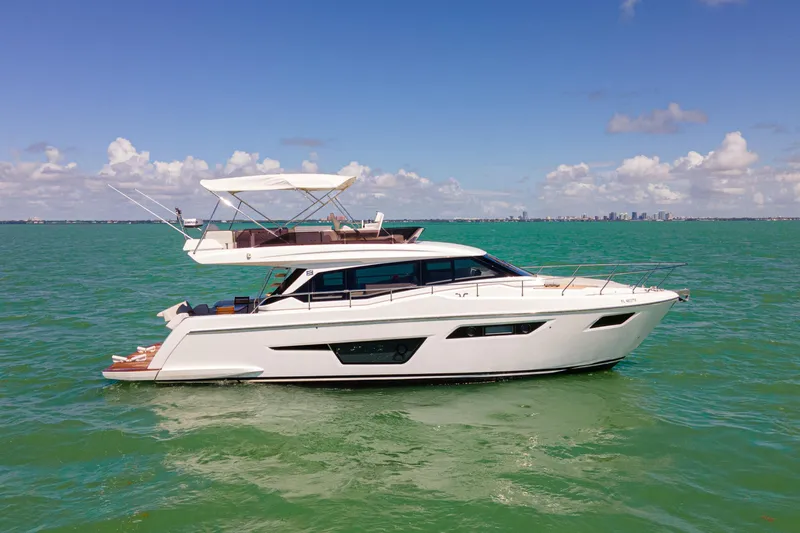 Avanti Yacht Photos Pics 2022 Ferretti Yachts 500 cruising on calm green waters under a clear blue sky.