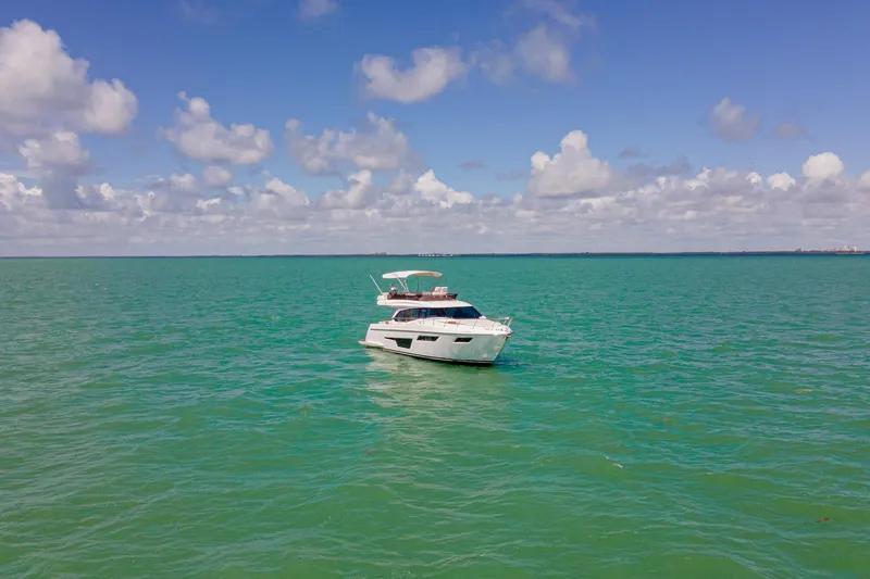Avanti Yacht Photos Pics 2022 Ferretti Yachts 500 cruising on turquoise ocean under blue sky.