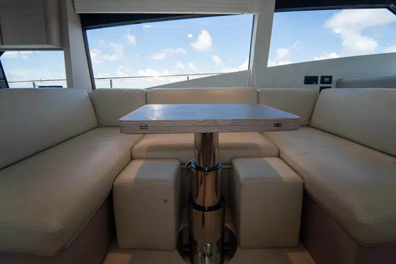 Avanti Yacht Photos Pics Luxurious interior of 2022 Ferretti Yachts 500 with elegant seating and table.