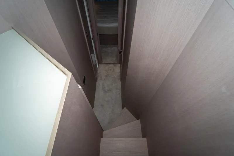 Avanti Yacht Photos Pics Staircase inside 2022 Ferretti Yachts 500, featuring modern wood paneling and sleek design.