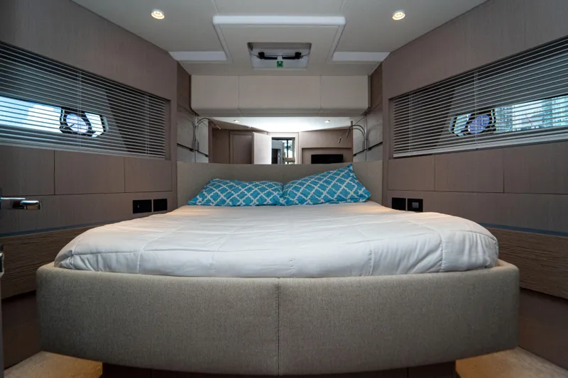 Avanti Yacht Photos Pics Luxurious bedroom interior of 2022 Ferretti Yachts 500 with modern design and cozy bedding.