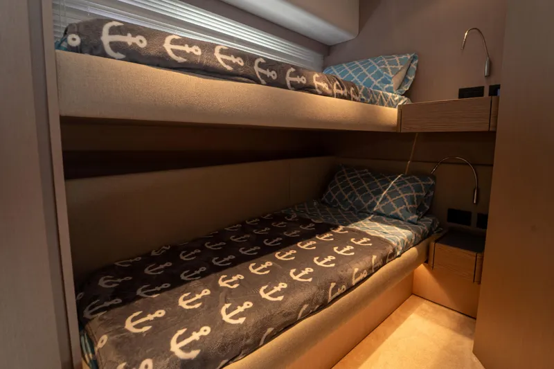Avanti Yacht Photos Pics Bunk beds in 2022 Ferretti Yachts 500 cabin with nautical-themed bedding.