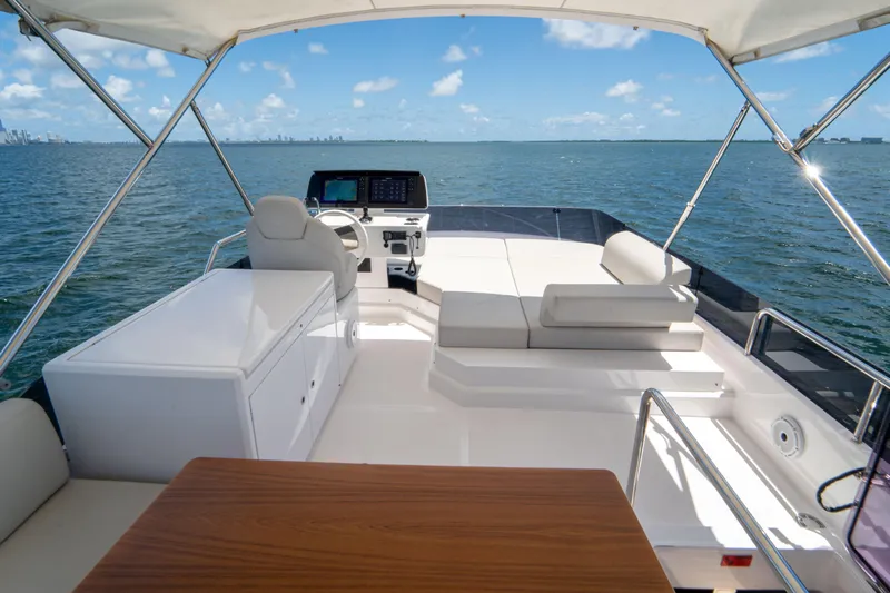 Avanti Yacht Photos Pics Luxurious 2022 Ferretti Yachts 500 flybridge with seating, helm, and ocean view.