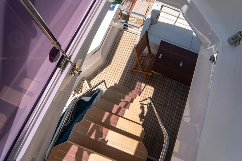 Avanti Yacht Photos Pics Staircase view on 2022 Ferretti Yachts 500, featuring elegant wooden deck and seating area.