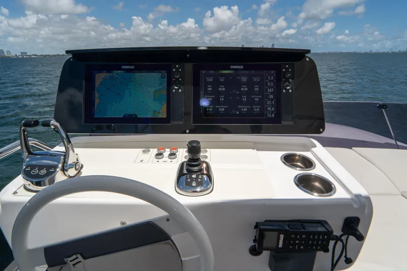 Avanti Yacht Photos Pics 2022 Ferretti Yachts 500 helm with dual Simrad displays, joystick, and controls.