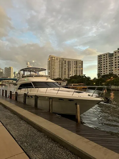 Chiquimu Yacht Photos Pics 2000 Sea Ray 480 Sedan Bridge yacht docked by urban waterfront.
