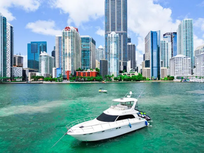 Chiquimu Yacht Photos Pics Sea Ray 480 Sedan Bridge yacht in vibrant city waterfront, 2000 model.