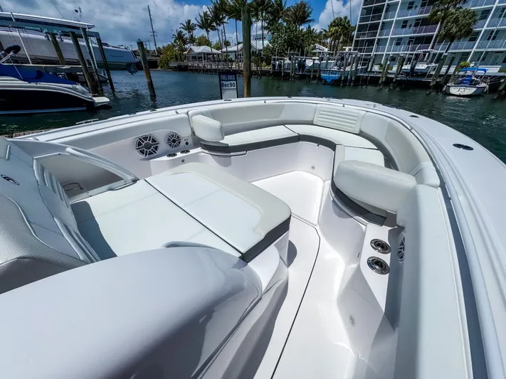  Yacht Photos Pics 2025 Edgewater 370CC boat interior with luxurious seating and modern design in a marina setting.