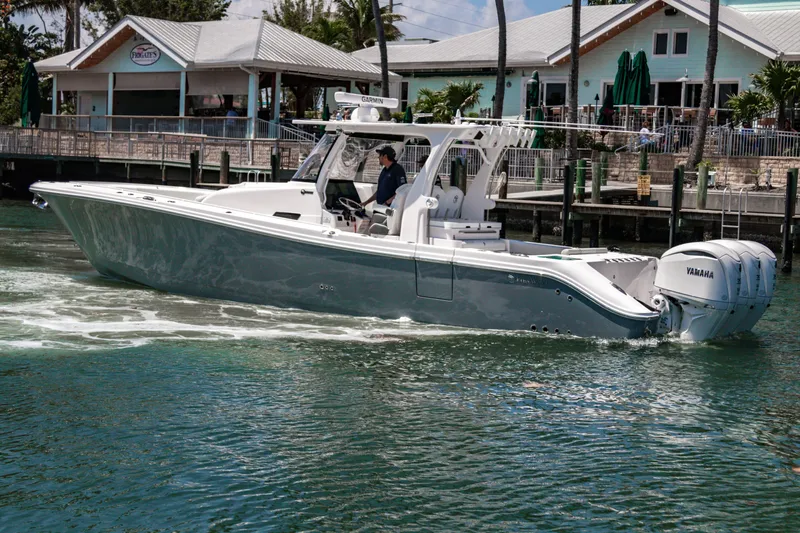 Yacht Photos Pics 2025 Edgewater 370CC boat cruising near a marina with Yamaha engines.